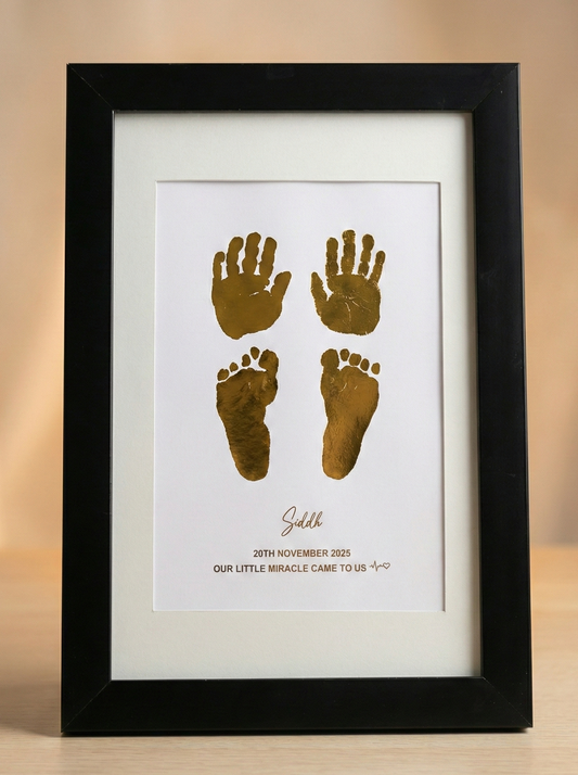 Framed print with gold hand and footprints